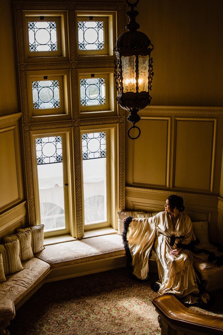 bride at window at cairnwood estate